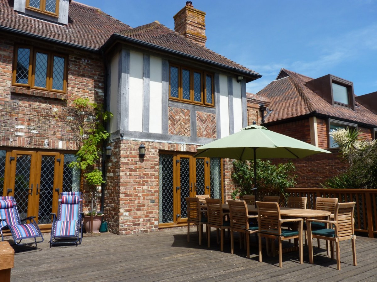Decked area with outdoor dining set and sun loungers